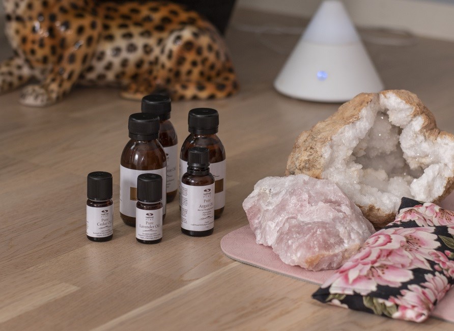pure lavender oil, eye pillow and essential oils in front of aroma lamp